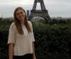 Melissa Nielsen stands in front of the Eiffel Towel in Paris
