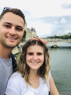 Josh Spencer and his wife, Lexi, stand by a river on a trip to Europe
