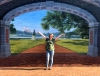 Sarah Stoddard stands in front of a mural on a wall in Dallas, Texas