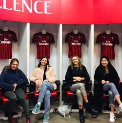 Mauren Fitzsimmons and three girls in her program pose for a photo in locker room during a San Siro Stadium tour.