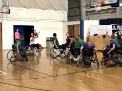 Students playing adaptive basketball