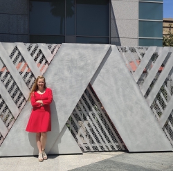 Clark stands in front of the Adobe logo at the Adobe San Jose office, where she interned after participating in the Adobe case competition. Photo courtesy of Autumn Clark.