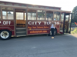 Ellis Long with the trolley bus she is renovating into a mobile barbershop. Photo courtesy of Afton Ellis Long.
