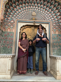 Arha and his family near his home in India. Photo courtesy of Karni Arha.