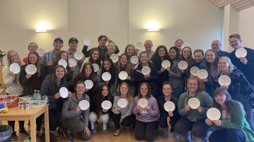 The ExDM group at the end of their trip. Students made paper plate awards to celebrate the experiences they had together. Photo courtesy of Mary Anderson.