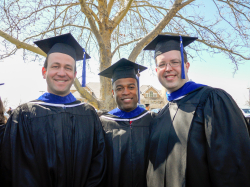 Hugh (center) at his MBA graduation. Photo courtesy of Ronell Hugh.
