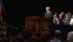 Larry Walters standing at a podium delivering remarks at a BYU devotional