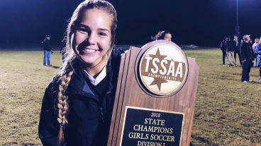 Bronson holds the Tennessee women's soccer state championship trophy.
