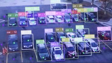 View of a parking lot of cars with vehicles individually tagged by color-coded boxes.