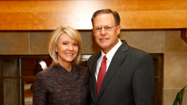 Barrett Slade and his wife, Patty, pose in front of fireplace