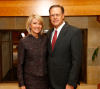 Barrett Slade and his wife, Patty, pose in front of fireplace