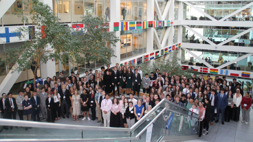 Student participants pose for a competition group photo on a landing in the Tanner building.