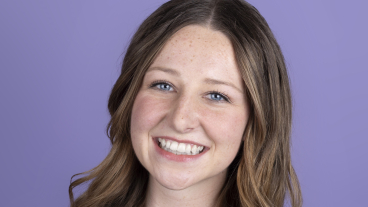 A professional headshot of Maile Berg smiling at the camera in front of a purple background.