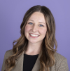 A professional headshot of Maile Berg smiling at the camera in front of a purple background.