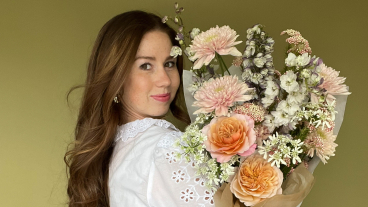 Gabrielle Sorensen holding a bouquet of flowers.