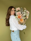 Gabrielle Sorensen holding a bouquet of flowers.