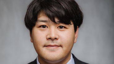 A professional headshot of Masahiro Hokazono.