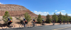 Ten cyclist in matching jerseys ride along a road through Utah.