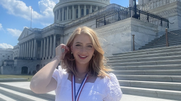 Anna Parry stands in front of the U.S. Capitol Building, wearing a gold medal.